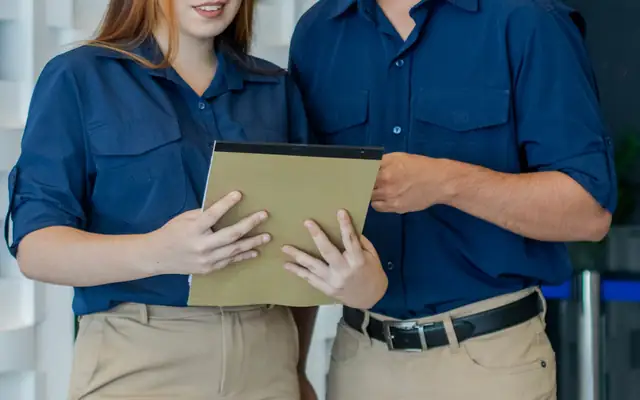 Staff in navy work shirts and khaki trousers